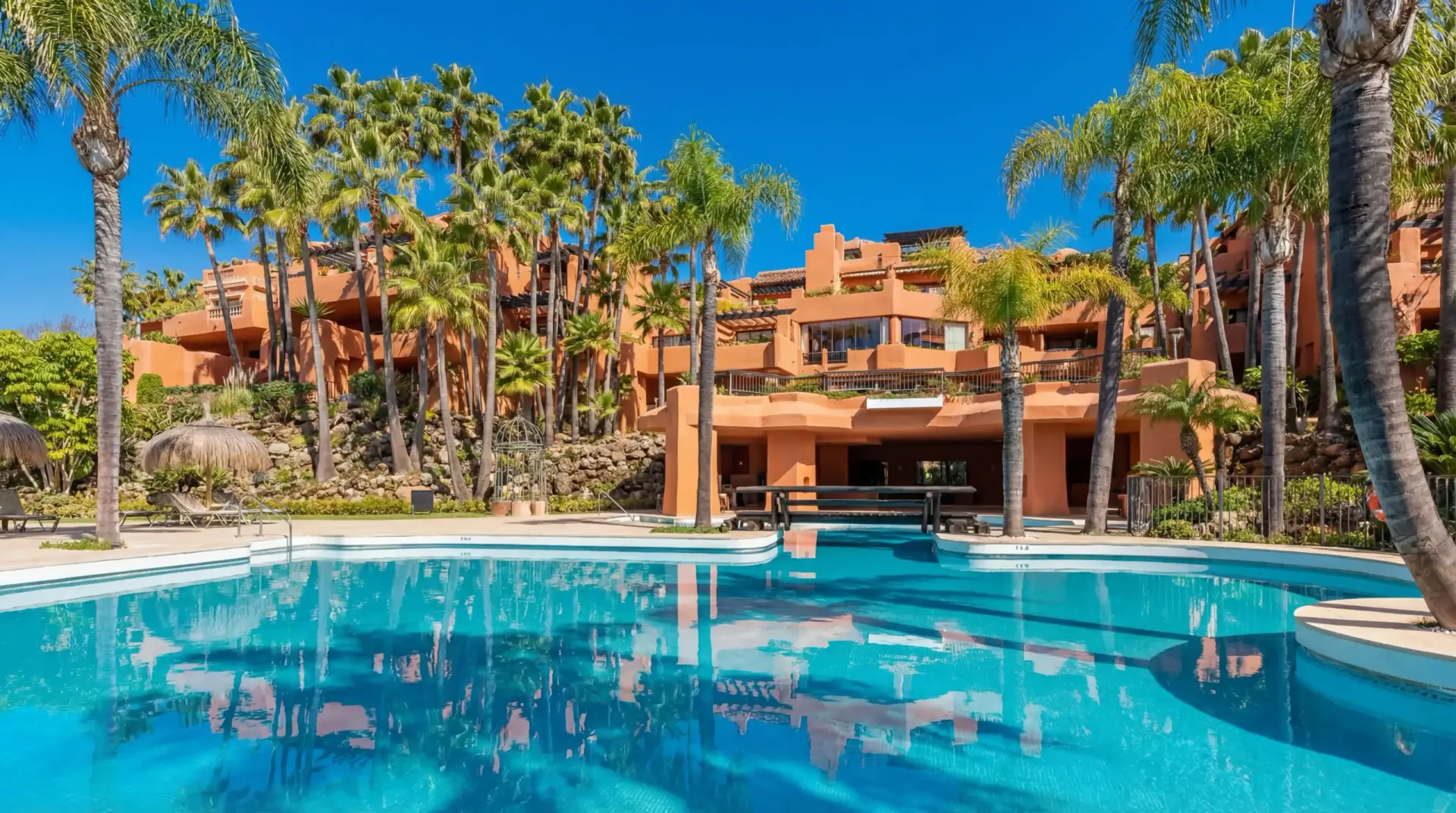 Luxury duplex penthouse in Nueva Andalucía Marbella with panoramic sea views, giant rooftop terrace, BBQ area, outdoor dining, and walking distance to Puerto Banús beach and marina.