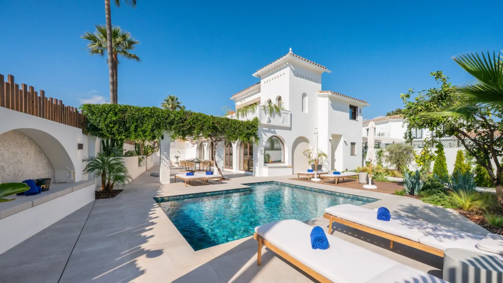 Luxury villa rental in Puerto Banús Marbella with heated private pool, tropical gardens, outdoor BBQ area, modern Mediterranean interiors and Costa del Sol holiday accommodation near beaches and golf courses