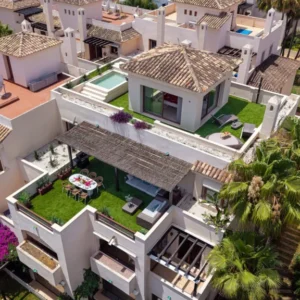 Luxury penthouse Marbella Nueva Andalucía aerial view with private heated pool, rooftop solarium, Golf Valley location, luxury terrace and panoramic views of Costa del Sol Spain near Puerto Banús